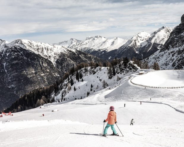 Mädchen fährt auf Ski auf dem Berg