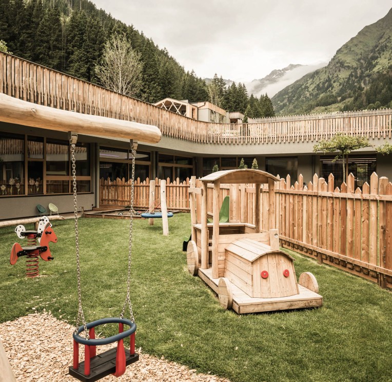 The new outdoor area of the Baby & Mini Room with swings, nest swings, wooden toy train, rocking horses and much more.