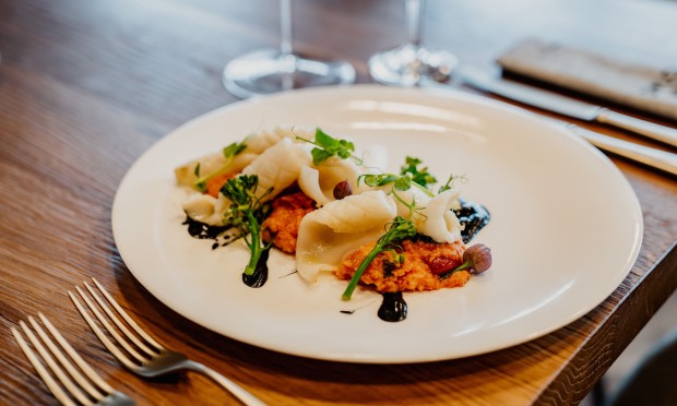 Ein elegant angerichteter Gourmetteller mit feinen Zutaten und stilvoller Präsentation.