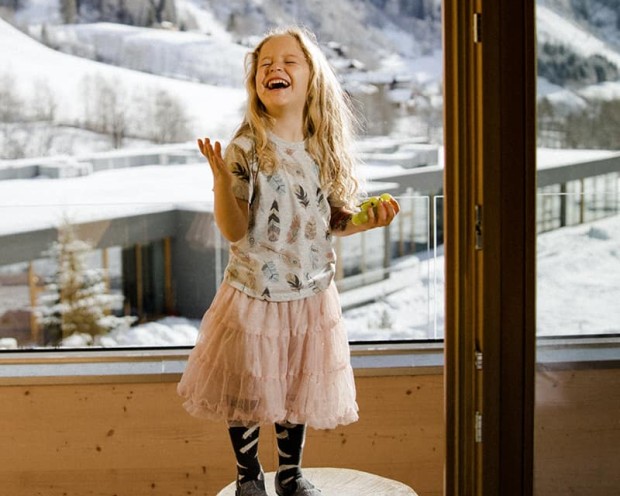 Happy girl in winter at the Feuerstein family hotel in South Tyrol