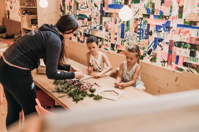 Educatrice fa lavoretti manuali con 2 bambini