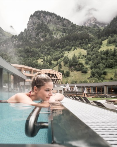 Frau liegt am Rande des Outdoor-Infinitypool