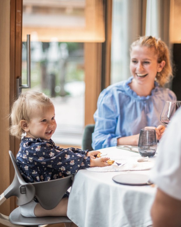 Kleines Kind am Esstisch mit Mutter und Vater