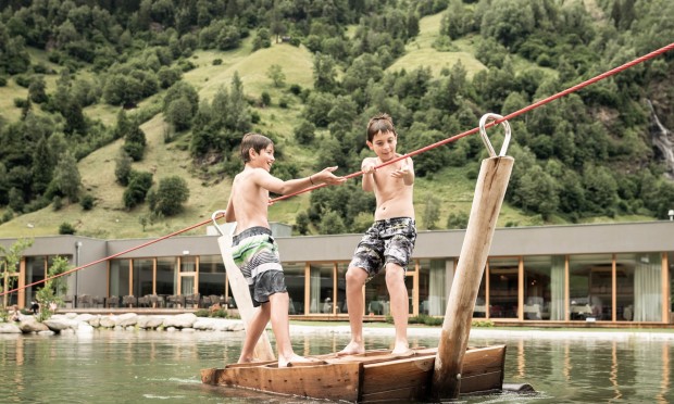 Zwei Jungs stehen auf dem Piratenboot und ziehen sich mit Seil zur anderen Seite