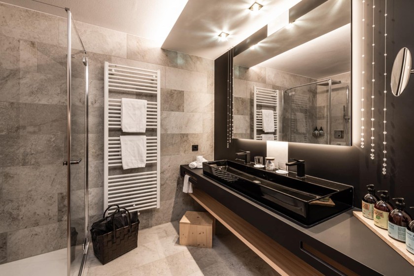 Bedezimmer mit Dusche und langem doppelten Waschbecken und großer Spiegel